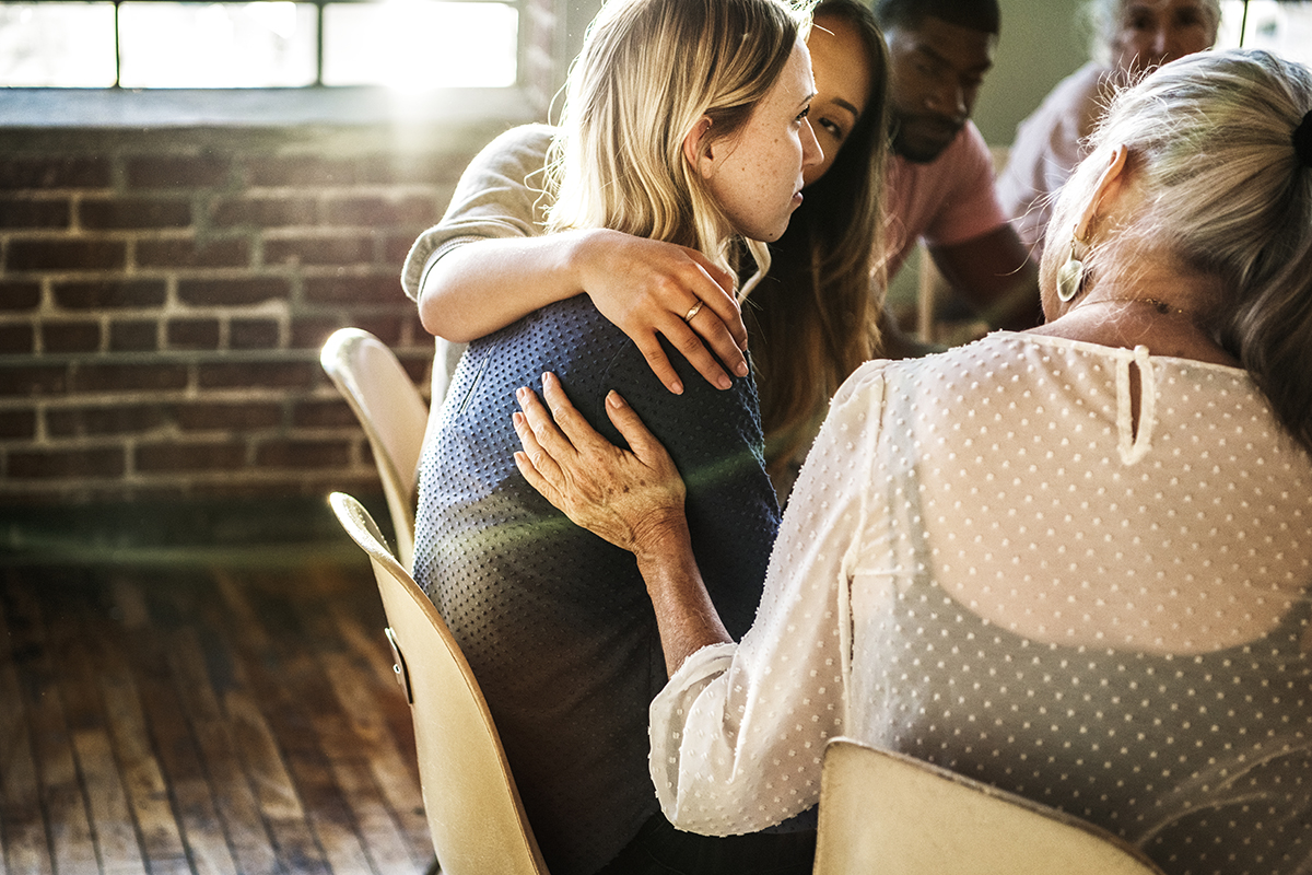 Women supporting each other looking at the benefits of group therapy