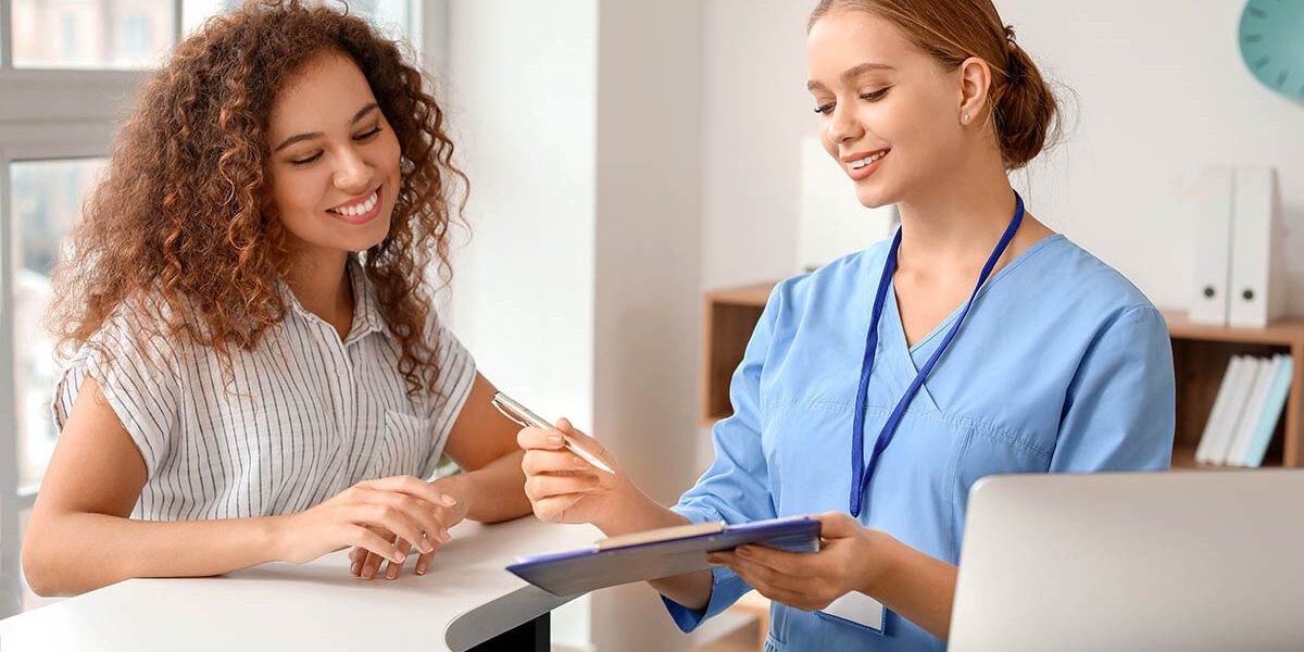 What to Expect in a Detox Program a medical professional holds a clipboard while talking to a woman patient about her options for detox in spokane washington