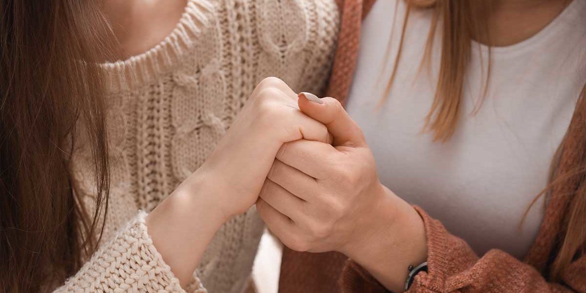 Recognizing-Suicide-Prevention-Day two people embrace for suicide prevention day