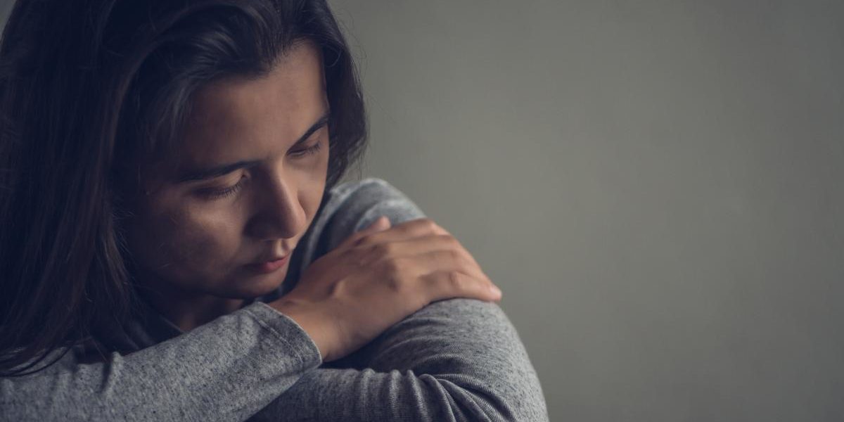 person in dark wondering what are synthetic drugs