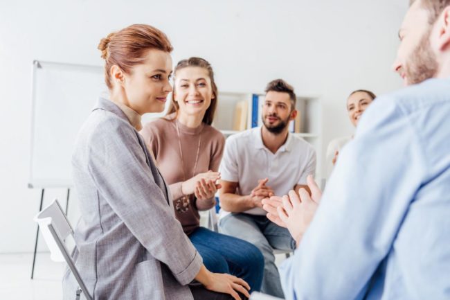 3 Benefits of a Residential Addiction Treatment Program a group of people discuss the benefits of a residential addiction treatment program