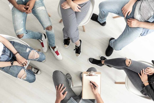 What to Look for in a Heroin Rehab Center a group of people seek treatment at a heroin addiction rehab center