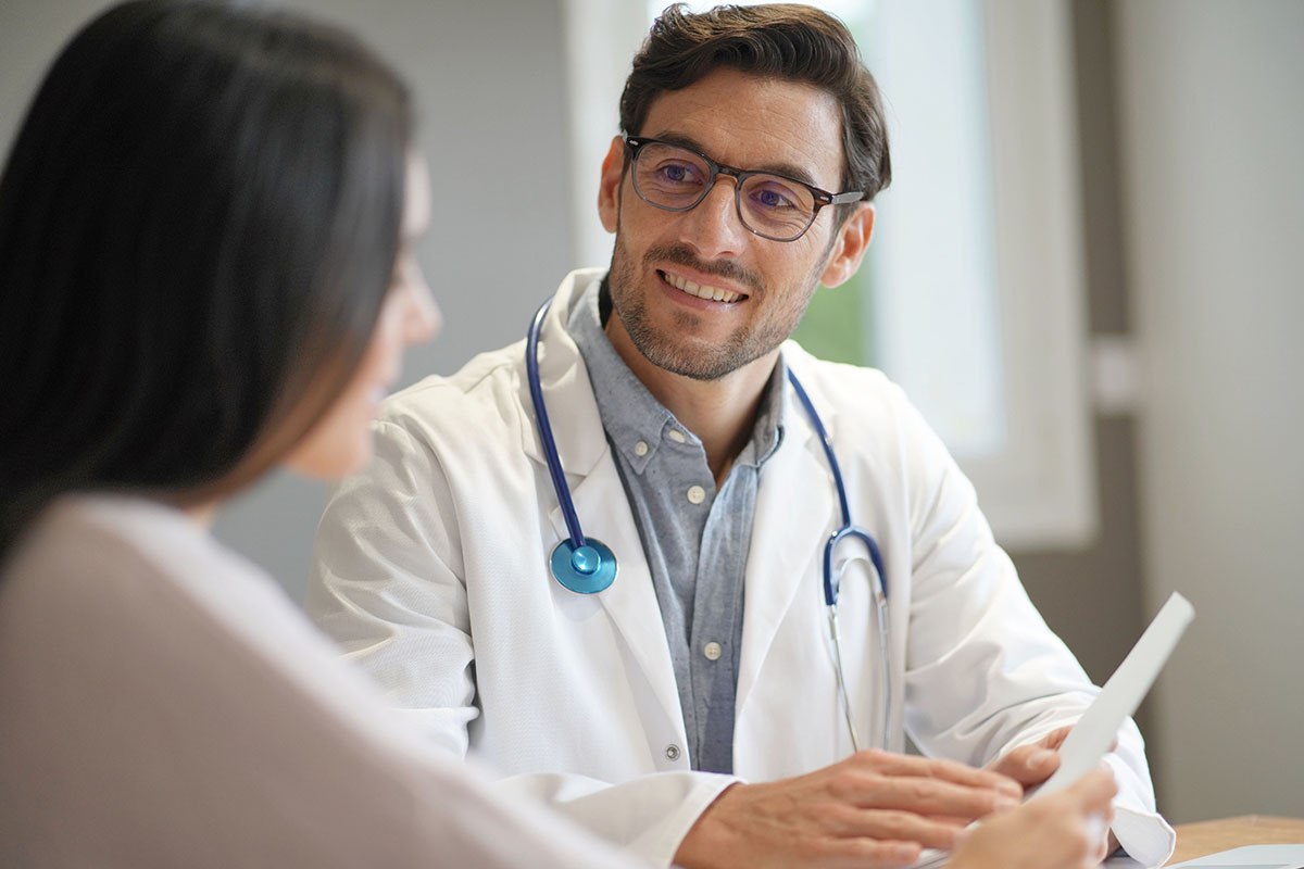 a woman sitting with her doctor and asking him when is a partial hospitalization program for me