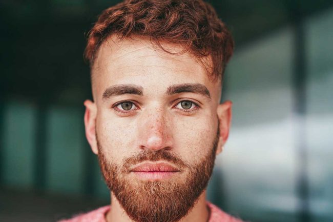4 Stages of Overcoming a Meth Addiction a man with a beard looks forward and thinks about how thankful he is for overcoming his meth addiction
