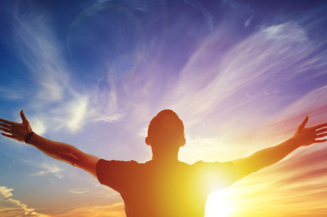 5 Steps to Overcome Meth Addiction a man is open armed toward the sunrise sky and feeling enlightened by learning how to overcome meth addiction