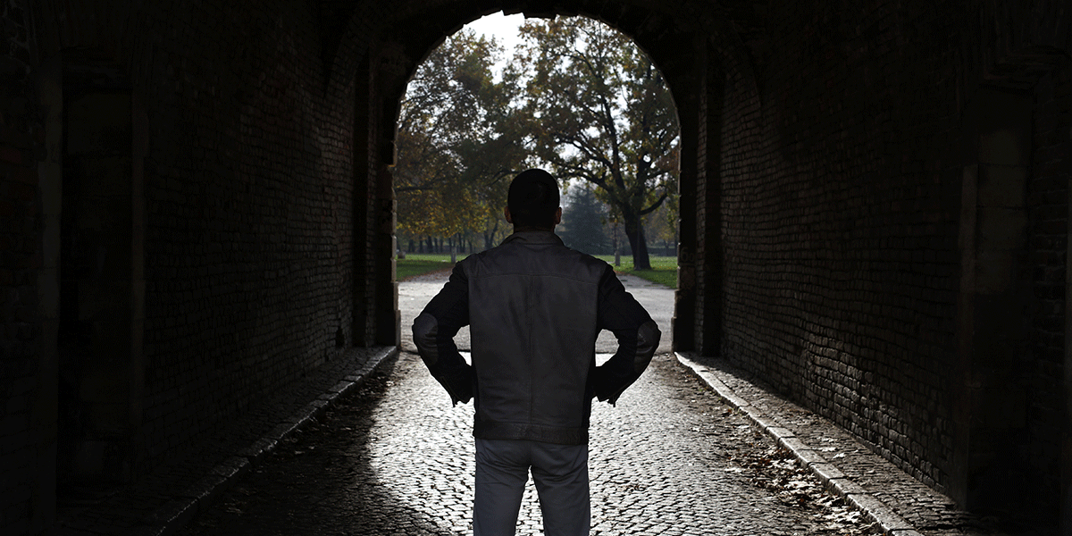 How-to-Start-Your-Recovery-to-Sobriety man stands outside in a dark tunnel and thinks about how to start his recovery to sobriety