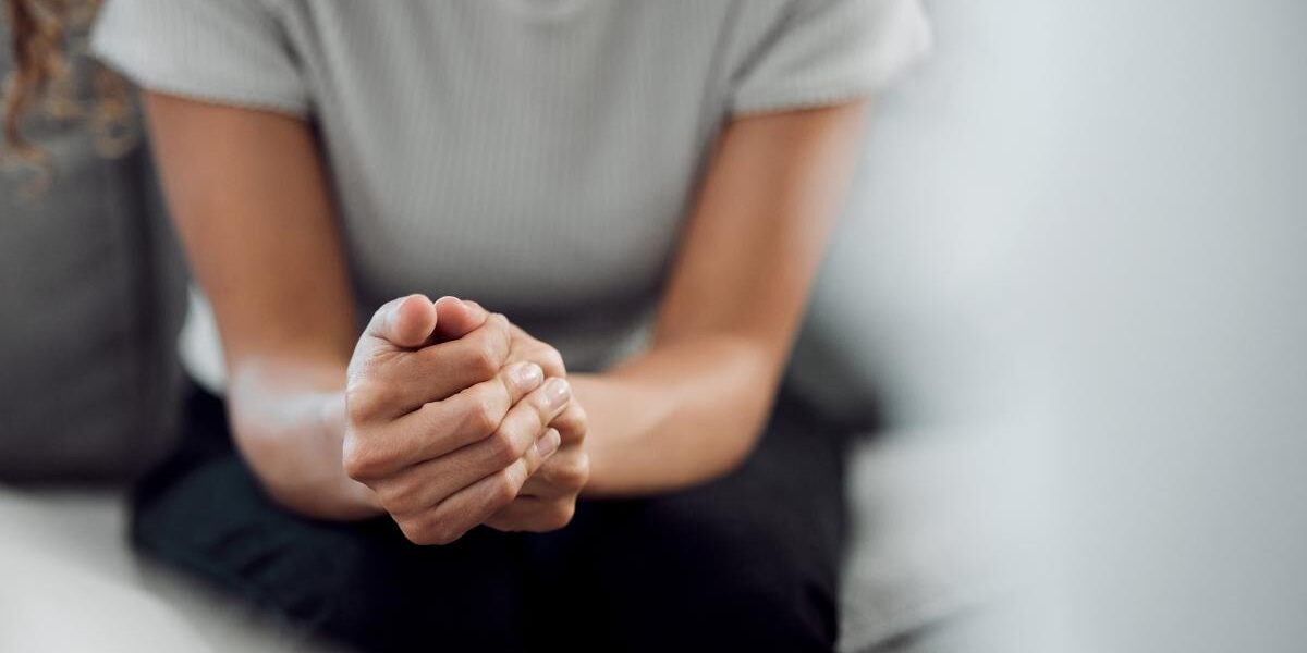 5 Tips to Help a Loved One with a Meth Addiction woman sits and holds her hands together in her lap wondering what to do when a loved one with meth addiction needs help