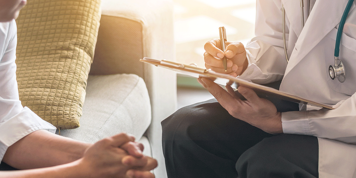 patient sits and leans in to listen to their doctors about how to find a detox center in spokane wa