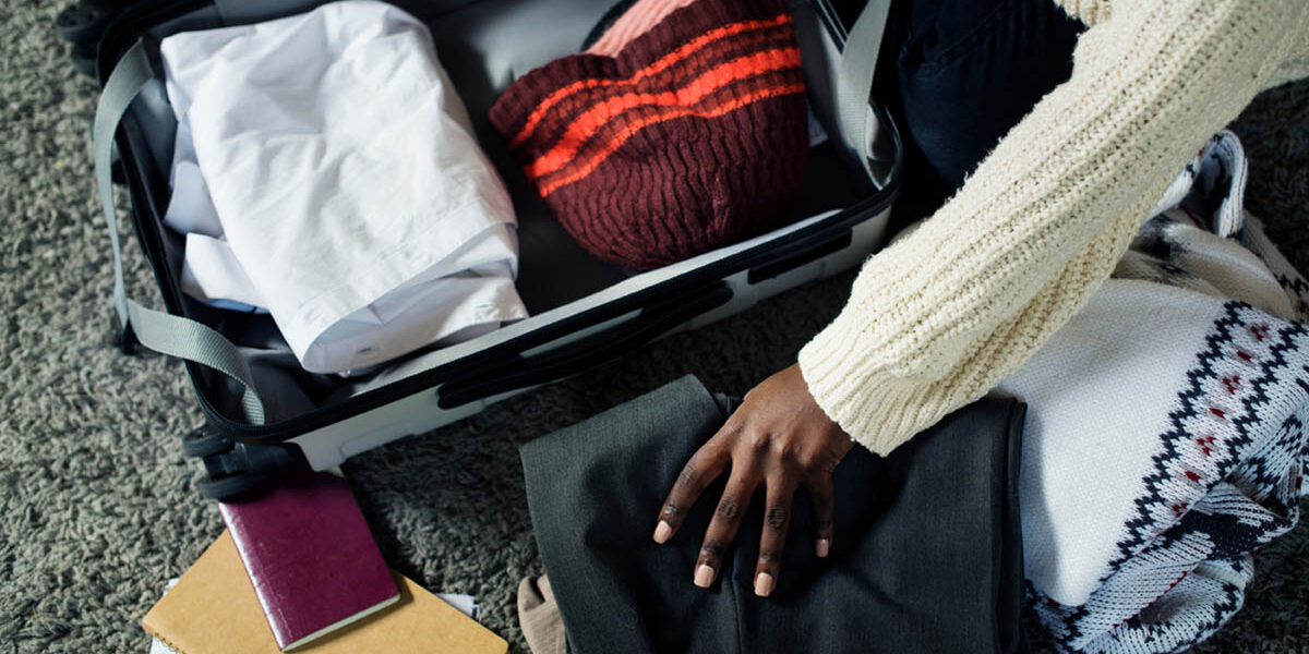 a person is packing their clothes in a suitcase for rehab and is wondering what to bring to rehab