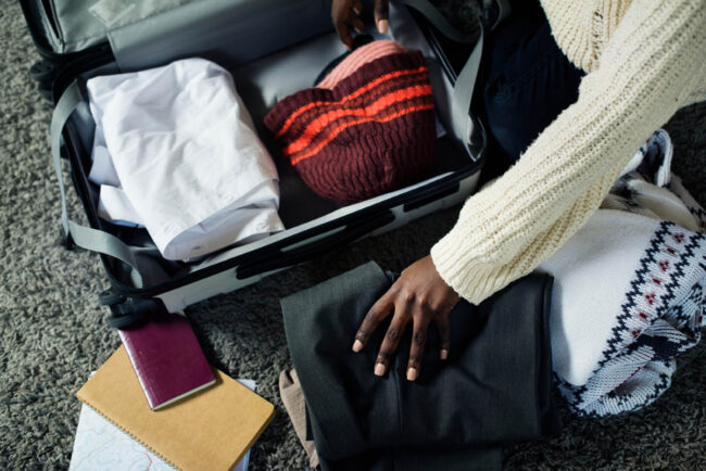 a person is packing their clothes in a suitcase for rehab and is wondering what to bring to rehab