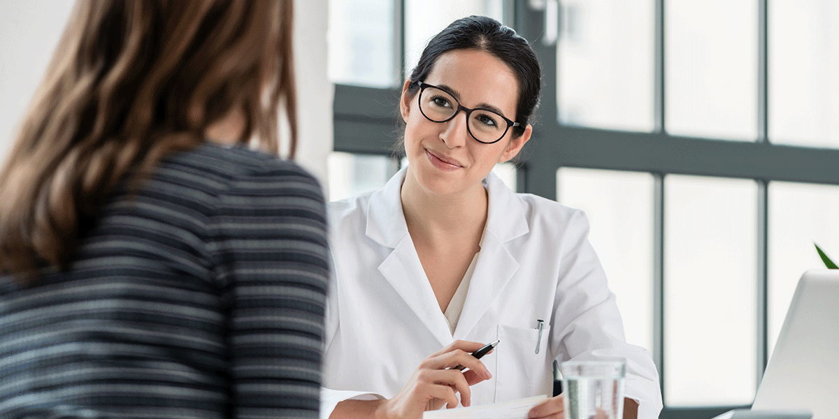 5-Benefits-of-a-Medical-Detox a medical professional sits at her desk listening to her patient after discussing some benefits of a medical detox
