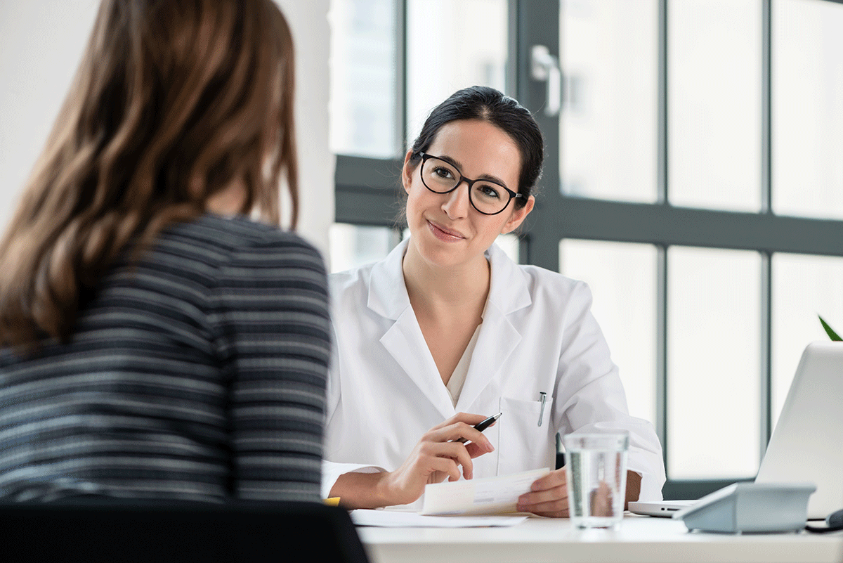 5-Benefits-of-a-Medical-Detox a medical professional sits at her desk listening to her patient after discussing some benefits of a medical detox