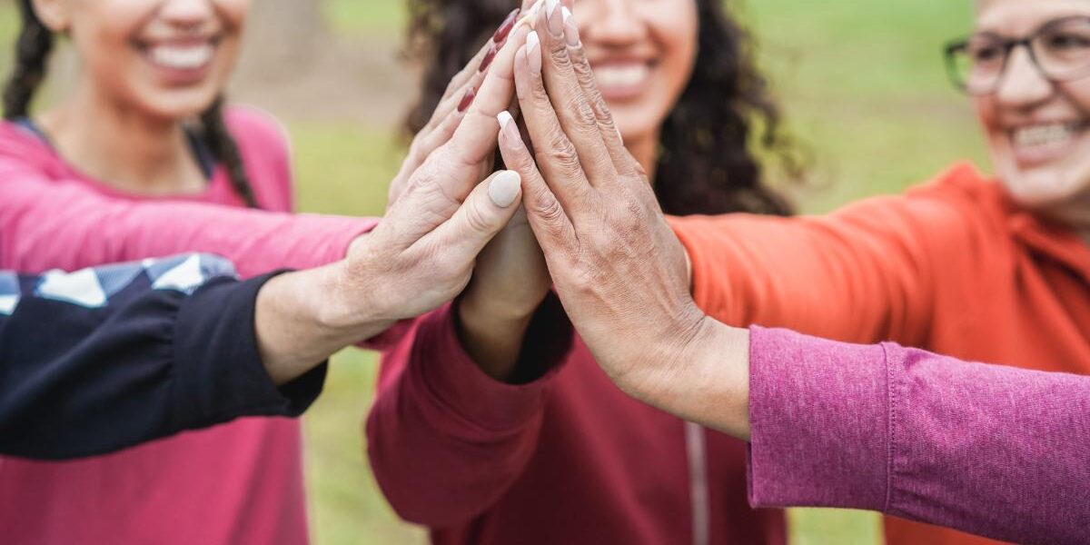 10 Facts Women In Recovery Should Know women in recovery stand together in a circle and high five in the middle of the circle