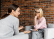 a woman sits on a couch talking to her therapist if cbt for alcohol use disorder could help her