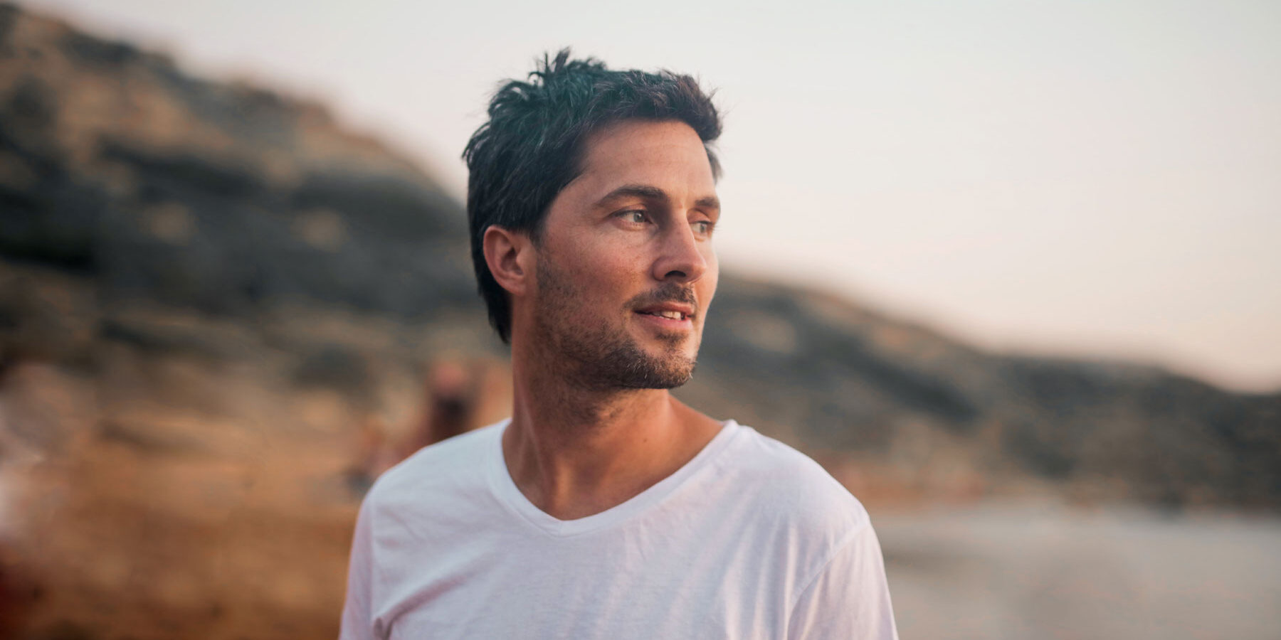 What Are the Long-Term Effects of Ambien Use man looks off into the distance on a hike and asks himself what are the long term effects of ambien