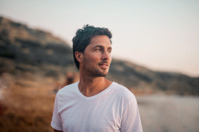 What Are the Long-Term Effects of Ambien Use man looks off into the distance on a hike and asks himself what are the long term effects of ambien