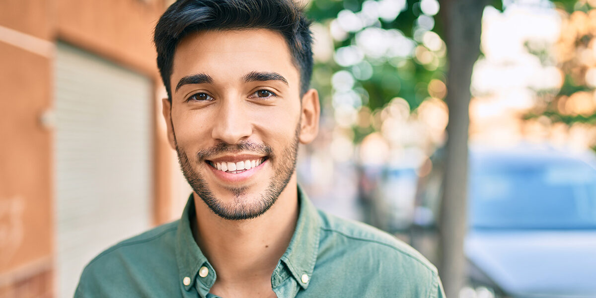 Tips For Long-Term Sobriety man stands outside looking forward into camera while thinking about tips for long-term sobriety