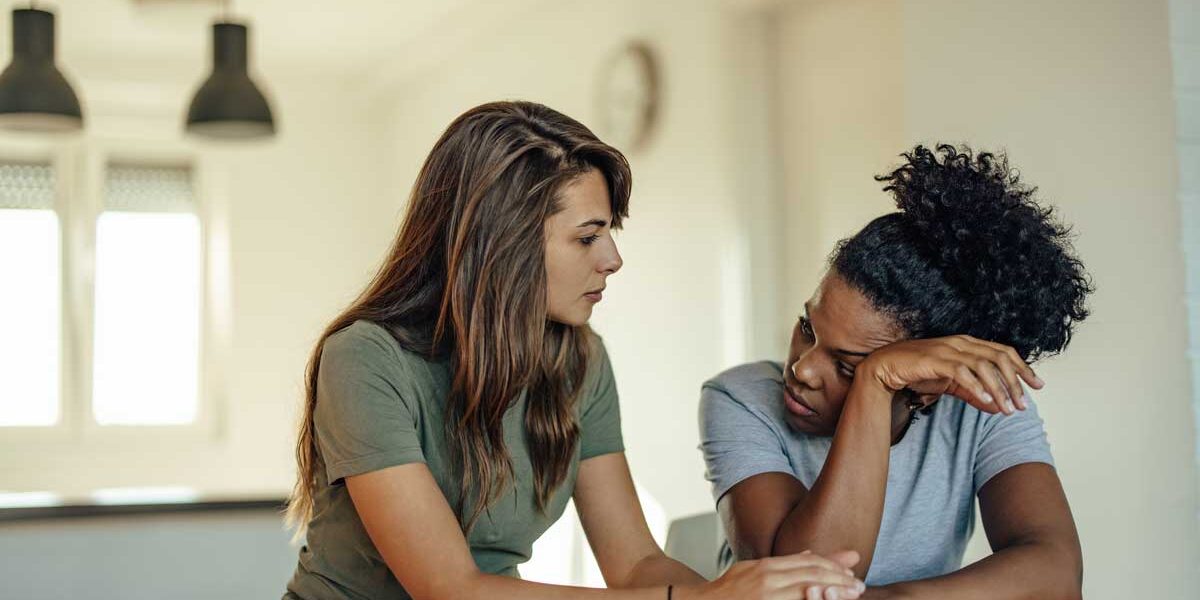 two women sit together and discuss ways on how to support a loved one in recovery