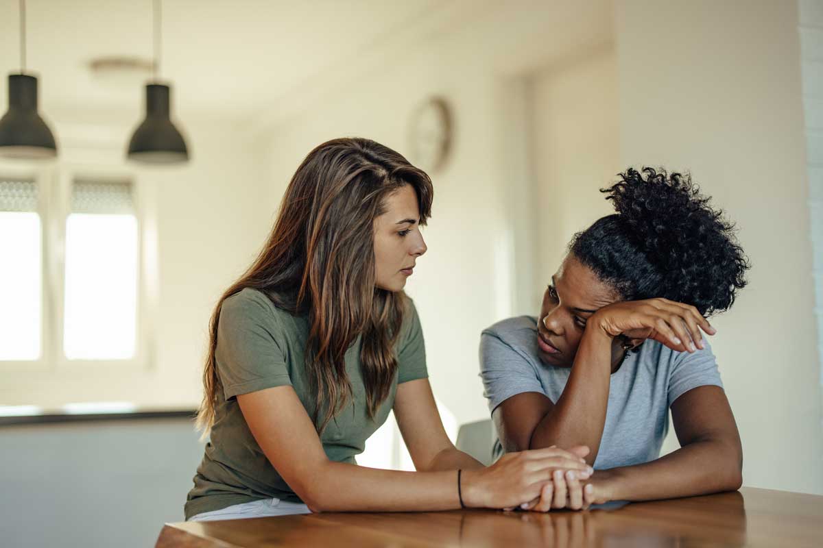 How To Support A Loved One In Recovery two women sit together and discuss ways on how to support a loved one in recovery