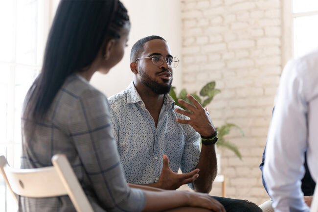 Man speaking in group therapy