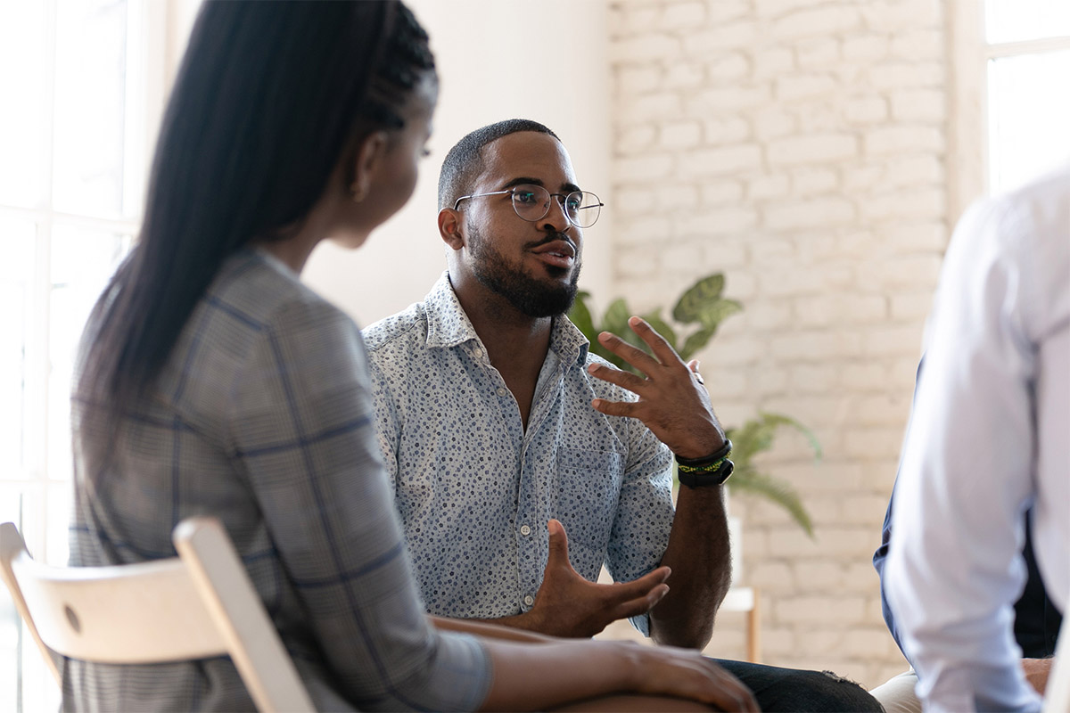 Man speaking in group therapy