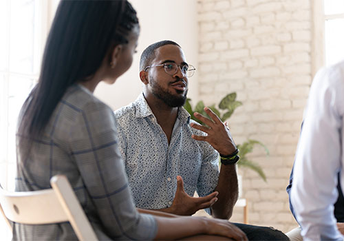 Man talking during group therapy