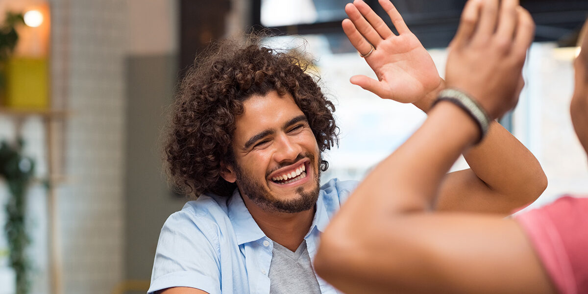 Spokane Treatment Outcomes & Success Rates of Rehab Two friends high-fiving successful recovery