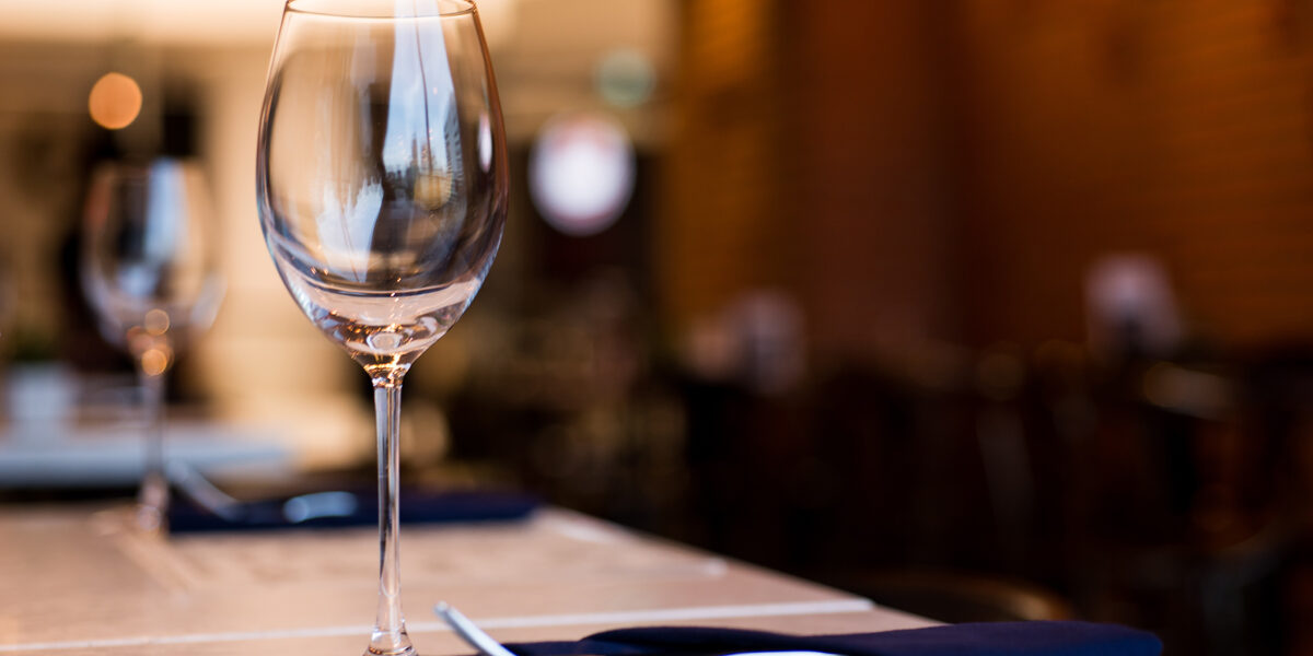 Alcohol-Use-Is-Changing-in-America—What-That-Means-for-Treatment-and-Recovery Empty wine glass at table