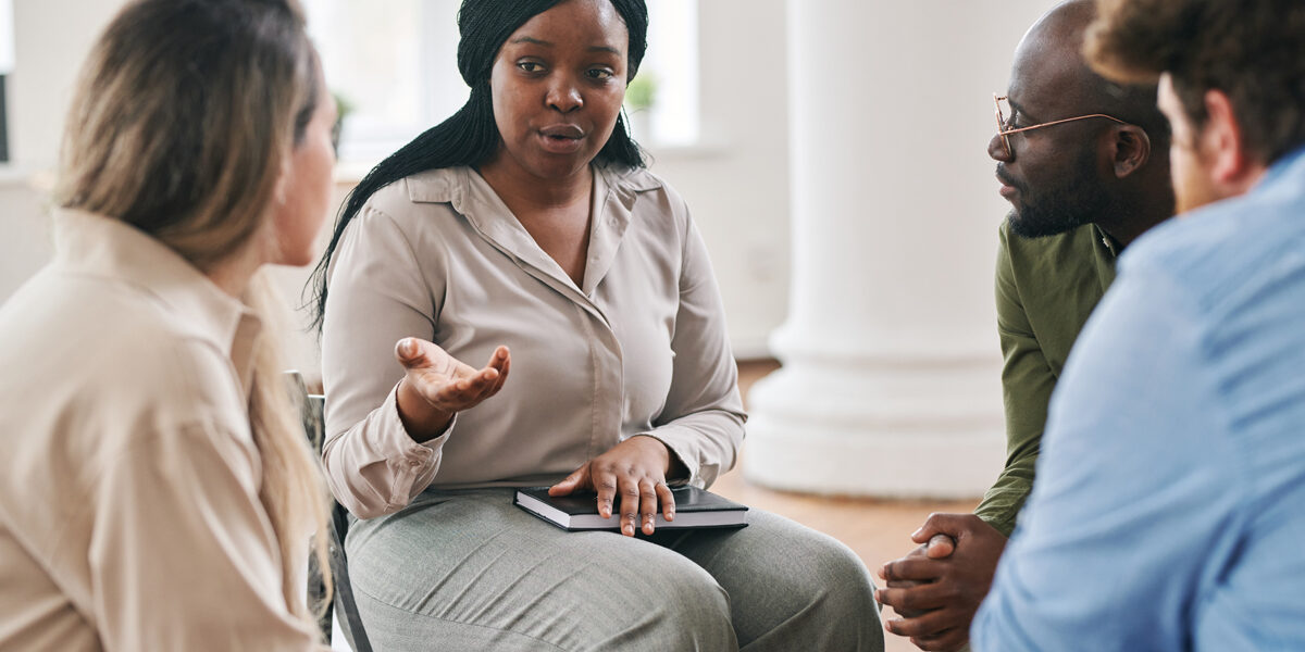 Recovery-Support-Groups-in-Spokane,-WA—AA,-NA,-SMART-Recovery,-and-More Woman speaking to others in group therapy session