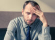 Man in business casual hungover at work