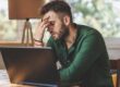 man feeling fatigued while working
