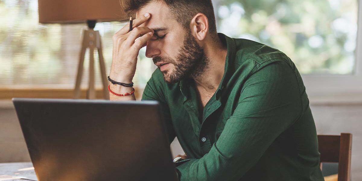 man feeling fatigued while working man feeling fatigued while working