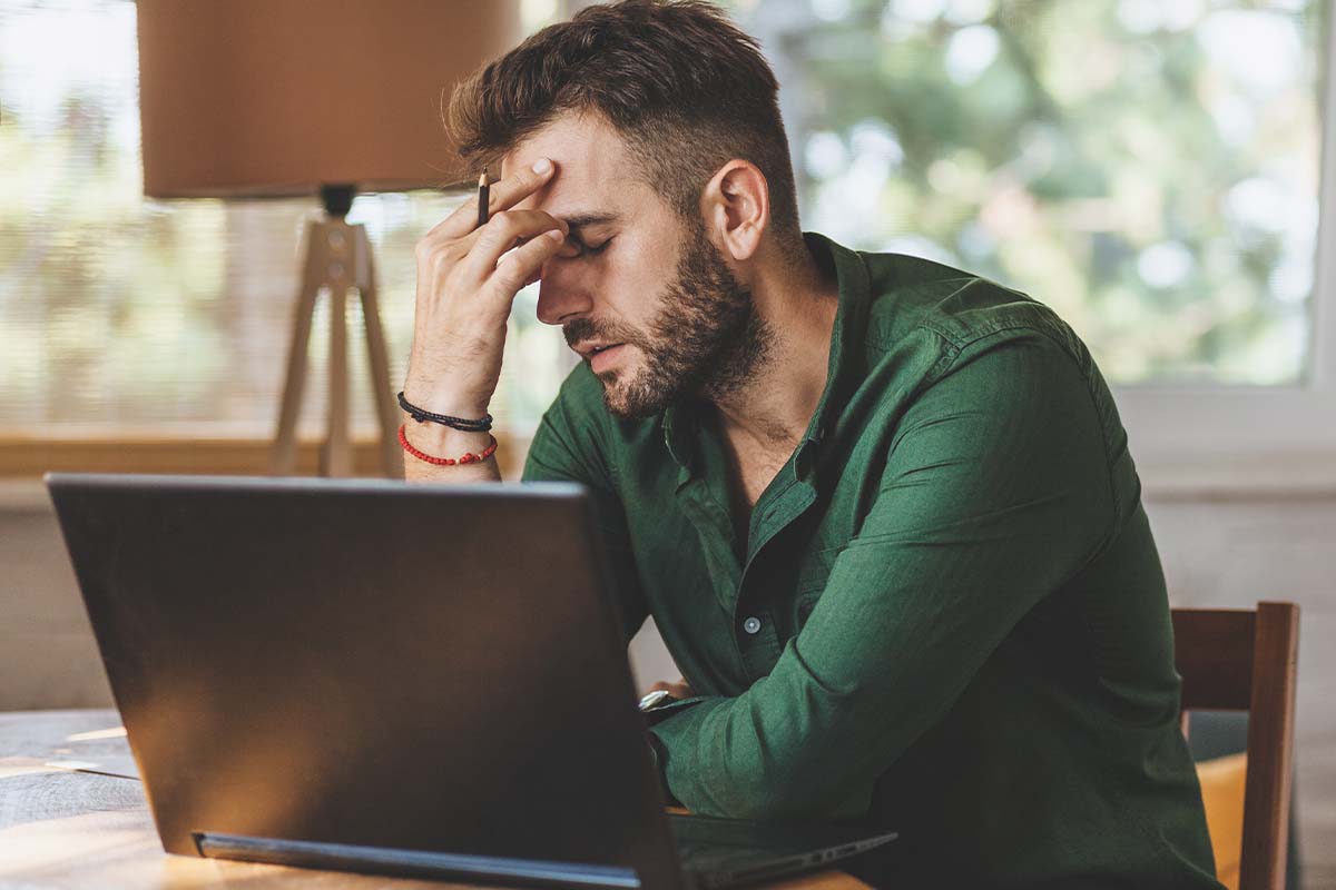 man feeling fatigued while working