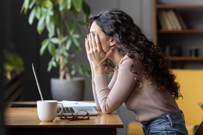 woman feeling tired while working woman feeling tired while working
